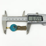 Digital caliper showing the Victorian turquoise and diamond tassel locket measuring approximately 61.54mm long.