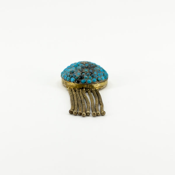 Low profile view of the Victorian turquoise locket showing the domed pavé setting and articulated gold tassels.