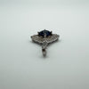 Top view of sterling silver charm with round blue CZ