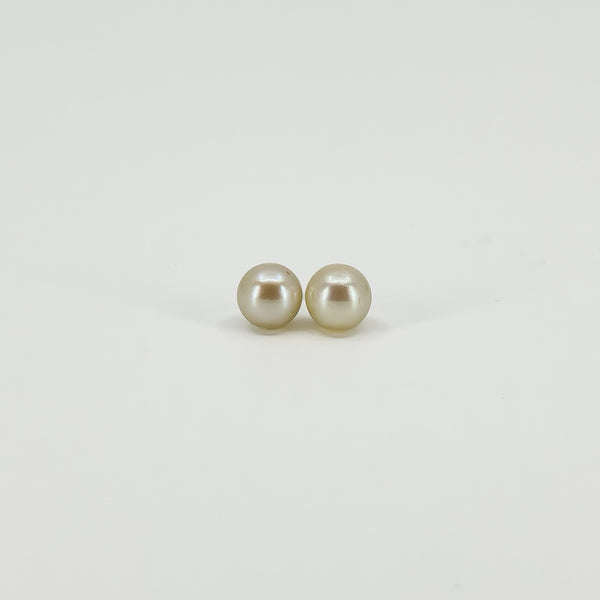 Front view of vintage 9ct gold stud earrings set with round white cultured pearls approximately 7mm in diameter.