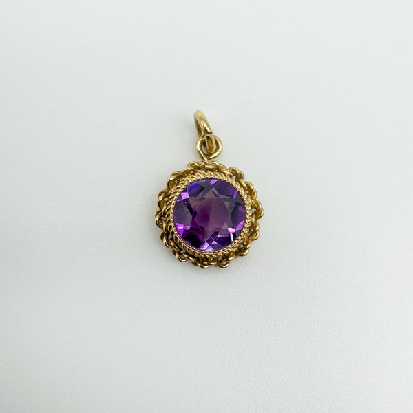 Close-up front view of vintage 9ct gold amethyst pendant with round cut stone
