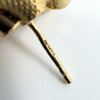 Close-up of a vintage 9ct gold earring post showing 375, import marks and date letter W.
