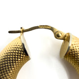 Close up of the 375 and assay marks on the 9ct gold mesh hoop earring fitting.