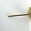 Close-up of a vintage 9ct gold pearl earring post showing the 375 stamp.