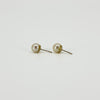 Side view of vintage 9ct gold pearl studs showing the round white cultured pearls, gold cups and post fittings.