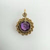Back of vintage gold pendant showing amethyst setting and open reverse