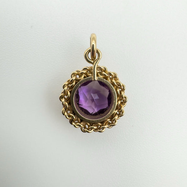Back of vintage gold pendant showing amethyst setting and open reverse