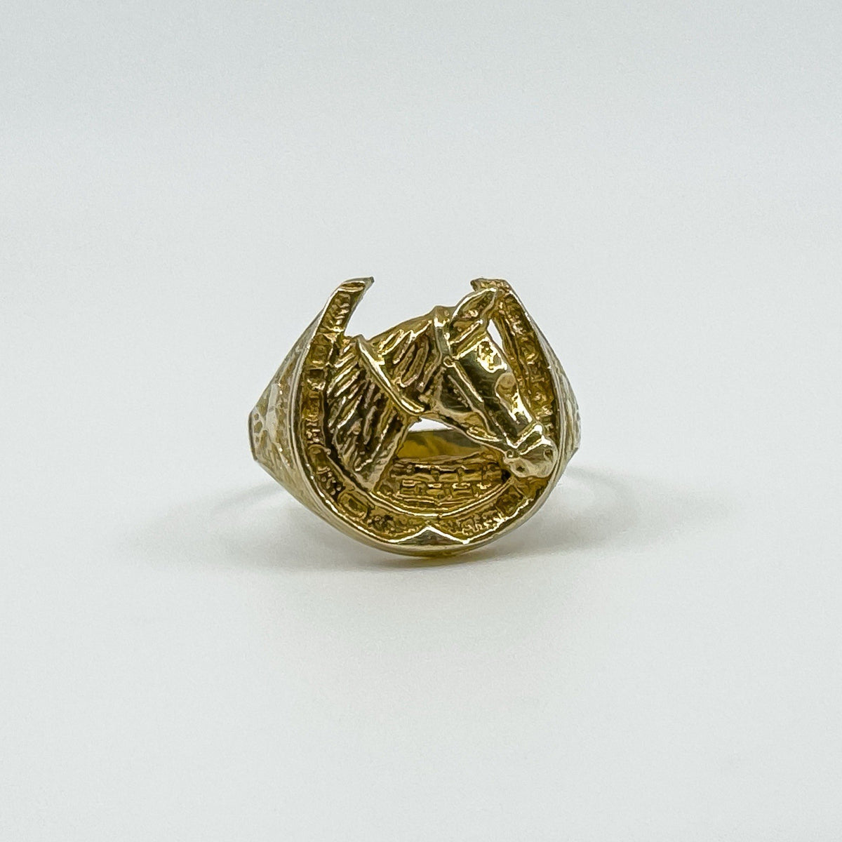 Front view of vintage 9ct gold horse head and horseshoe ring, UK Size U, showing the detailed equestrian design.