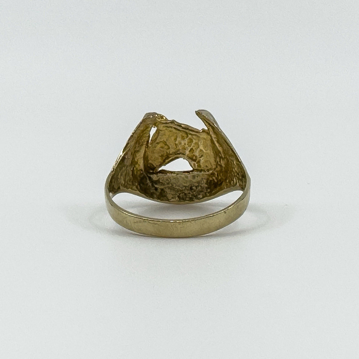 Rear view of vintage 9ct gold horse head and horseshoe ring showing the open-backed head and plain gold band.