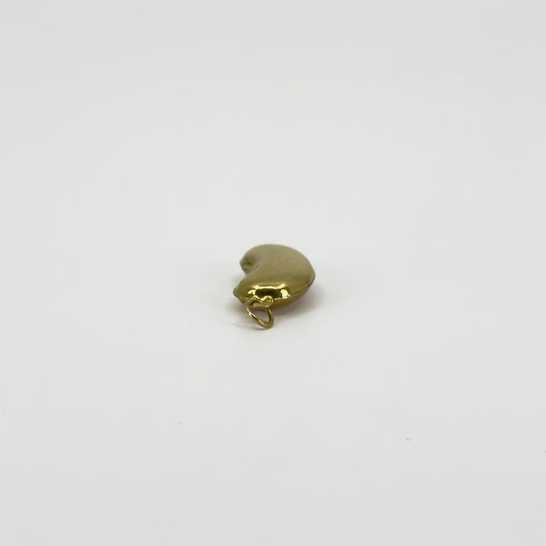 Angled view of vintage 9ct gold lucky bean charm pendant showing its curved hollow form and gold hoop.