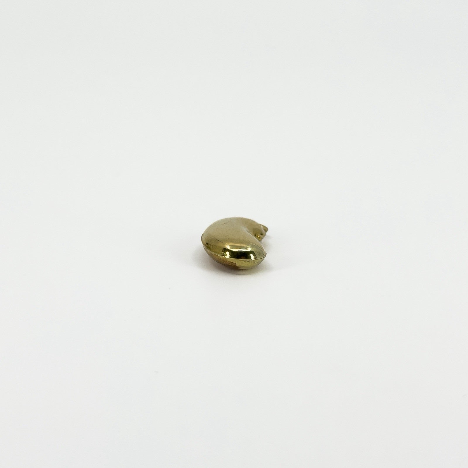End view of vintage 9ct gold lucky bean charm pendant showing its rounded three-dimensional kidney bean form.
