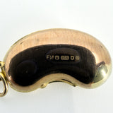 Close-up of vintage 9ct gold lucky bean charm showing FM, crown, 375, London leopard’s head and 1977 date letter.