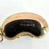 Close-up of vintage 9ct gold lucky bean charm showing FM, crown, 375, London leopard’s head and 1977 date letter.