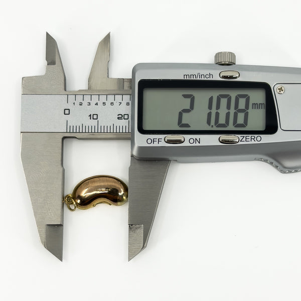 Vintage 9ct gold lucky bean charm pendant measured at approximately 21mm long with digital calipers.