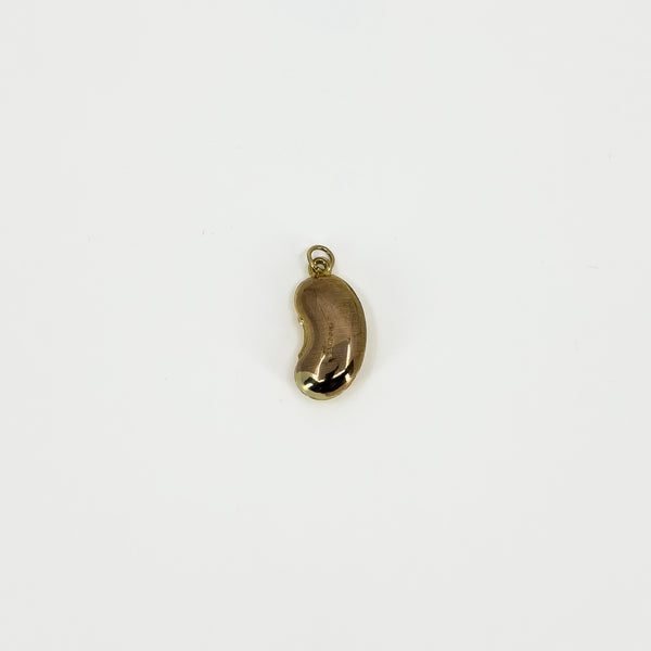 Reverse view of vintage 9ct gold lucky bean charm pendant showing its polished surface and suspension hoop.