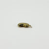 Side view of vintage 9ct gold lucky bean charm pendant showing its hollow three-dimensional form and hoop.