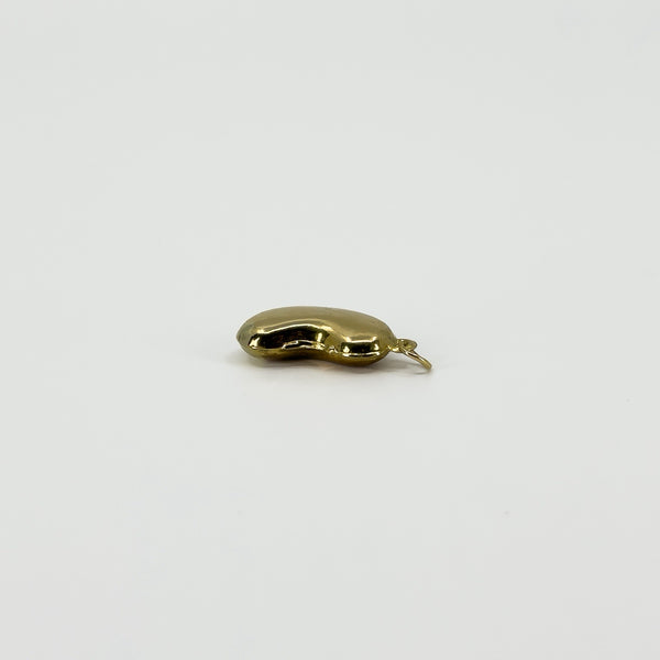 Side view of vintage 9ct gold lucky bean charm pendant showing its hollow three-dimensional form and hoop.