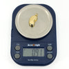 Vintage 9ct gold lucky bean charm pendant weighing approximately 0.91g on digital scales.