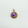 Overhead photo of vintage 9ct gold amethyst pendant with twisted border