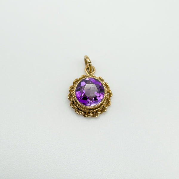 Overhead photo of vintage 9ct gold amethyst pendant with twisted border