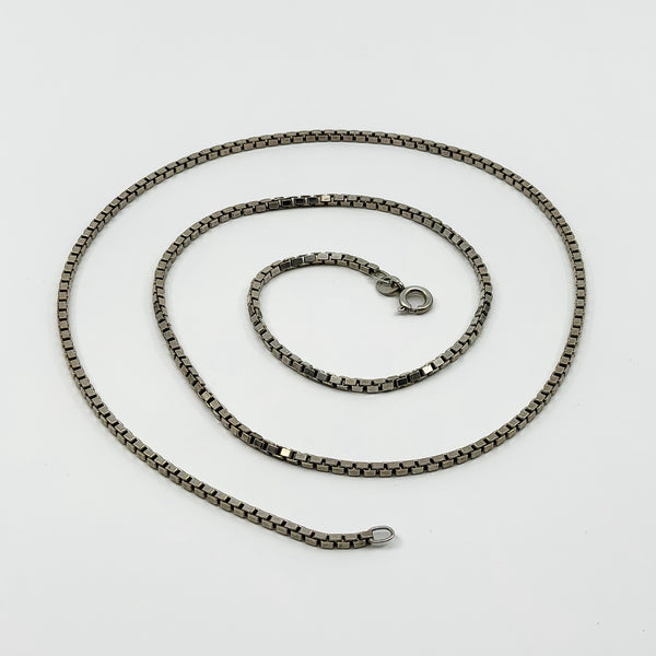 Vintage sterling silver box chain necklace laid flat, showing the square links and spring clasp.