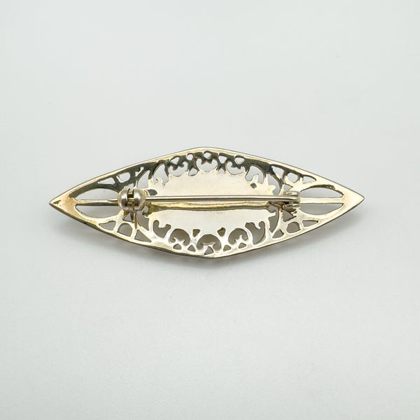 Back of vintage silver brooch with rolling C-clasp and openwork Celtic design
