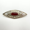 Carnelian cabochon brooch in vintage sterling silver with decorative openwork frame
