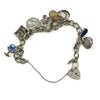 Back view of vintage sterling silver charm bracelet with oval links, safety chain and mixed hanging charms.