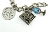 Close up of vintage sterling silver charm bracelet with 925 disc charm, blue crystal globe and mill charm.