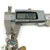 Vintage sterling silver charm bracelet link measurement shown as approximately 6.99mm with charms visible.