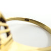 Close-up of the GS hallmark inside the 18ct gold ruby emerald and diamond cluster ring band