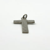 Close up of the engraved foliate detail on the vintage sterling silver cross pendant.