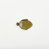 Side view of vintage 9ct gold spinning fob pendant showing round frame, bail and moving disc