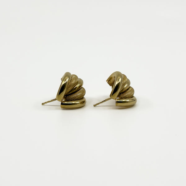 Side view of vintage 9ct gold half hoop earrings showing polished and mesh-textured curved strands.