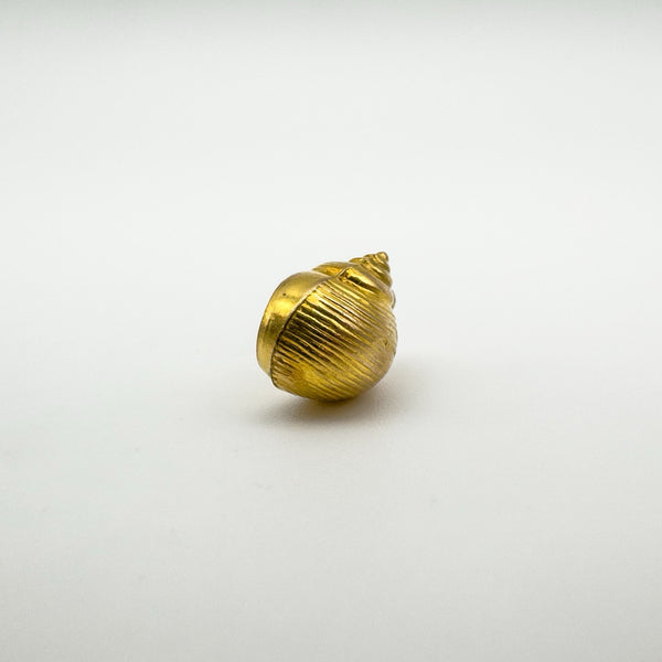 Base view of vintage 9ct gold sea shell charm showing spiral shape