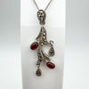 Detailed view of vintage carnelian and marcasite pendant on stand