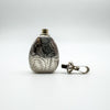 1994 silver perfume bottle pendant with engraved lid unscrewed and laid beside