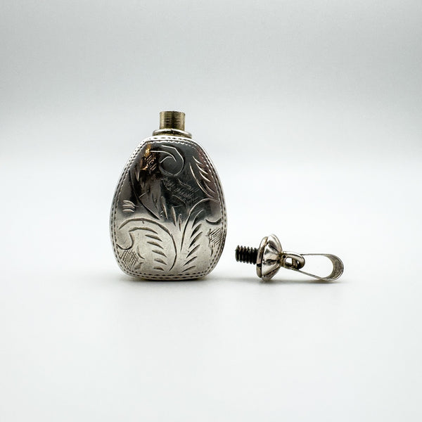 1994 silver perfume bottle pendant with engraved lid unscrewed and laid beside