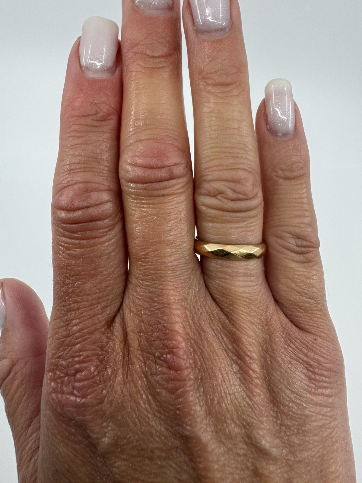 Vintage 18ct rose gold faceted full band ring shown worn on the hand for scale and fit.