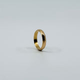 Side view of vintage 18ct rose gold faceted band ring showing the polished faceted surface.