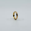 Side view of vintage 18ct rose gold faceted band ring showing the polished faceted surface.