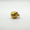 Side profile of vintage 9ct gold sea shell charm showing full form