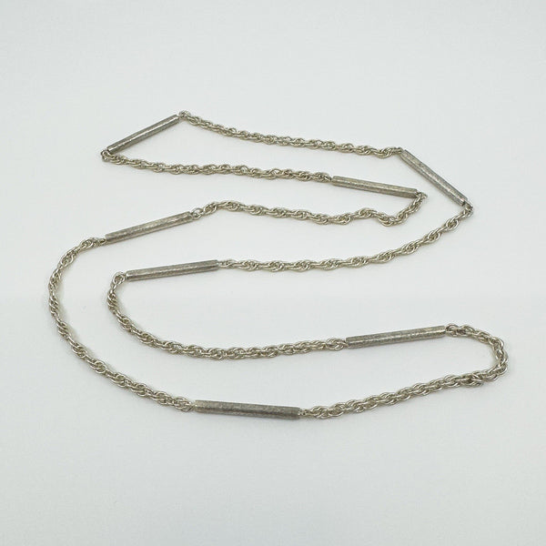 Close-up of vintage sterling silver chain with twisted and tubular bar links