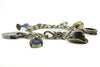 Low angle view of vintage sterling silver charm bracelet with lapis lazuli, cowboy hat and ring charms.