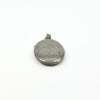 Close side view of a vintage sterling silver locket with foliate engraving