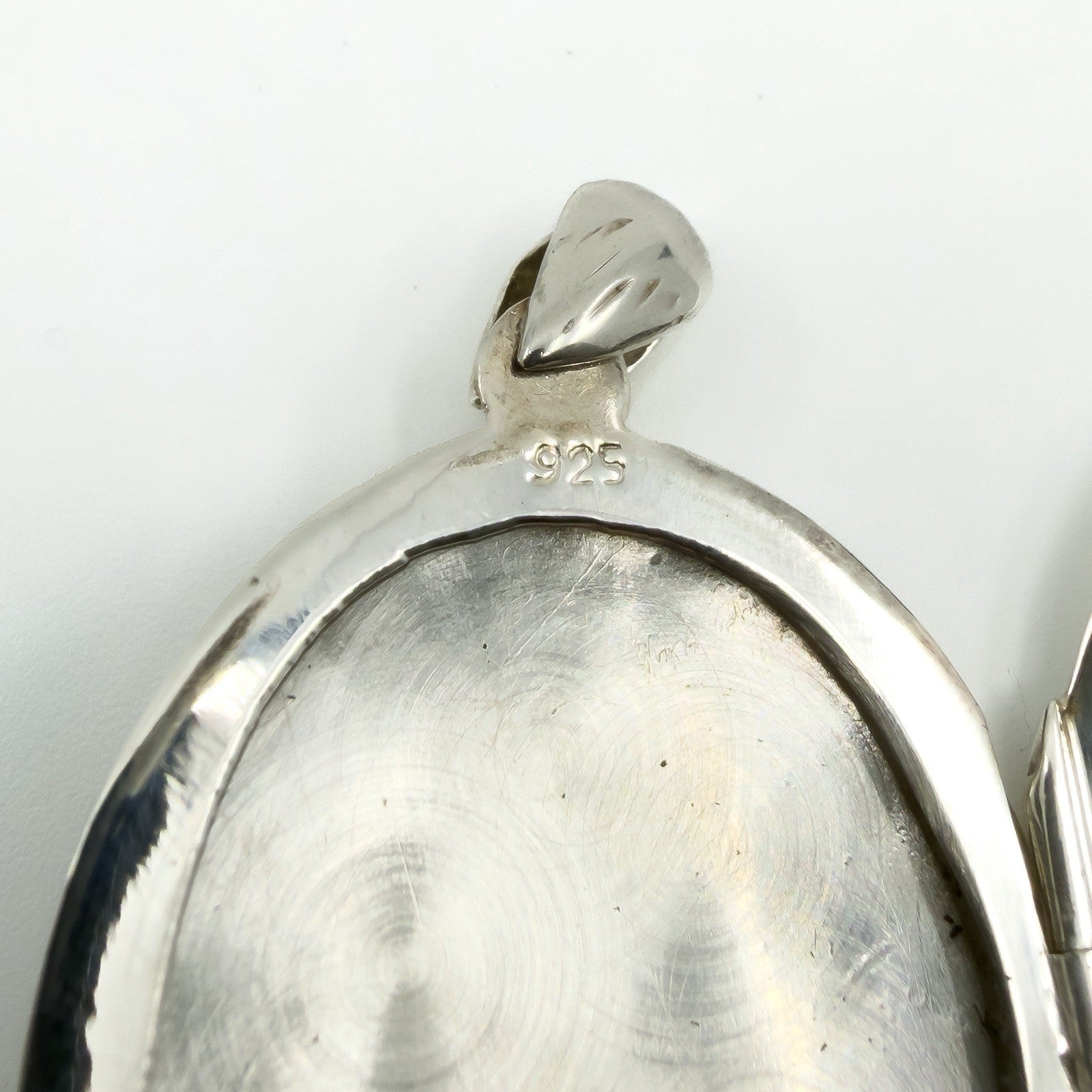 Close up of the 925 stamp inside the sterling silver oval photo locket