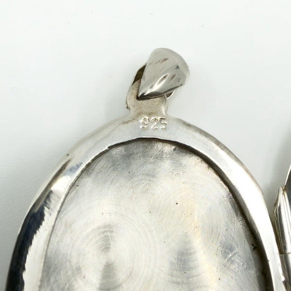 Close up of the 925 stamp inside the sterling silver oval photo locket