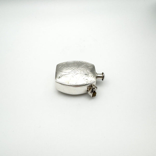 Chunky vintage silver perfume or poison bottle pendant shown lying flat