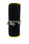 Vintage sterling silver charm bracelet on black display with 925 disc, mill charm and blue crystal globe charm.