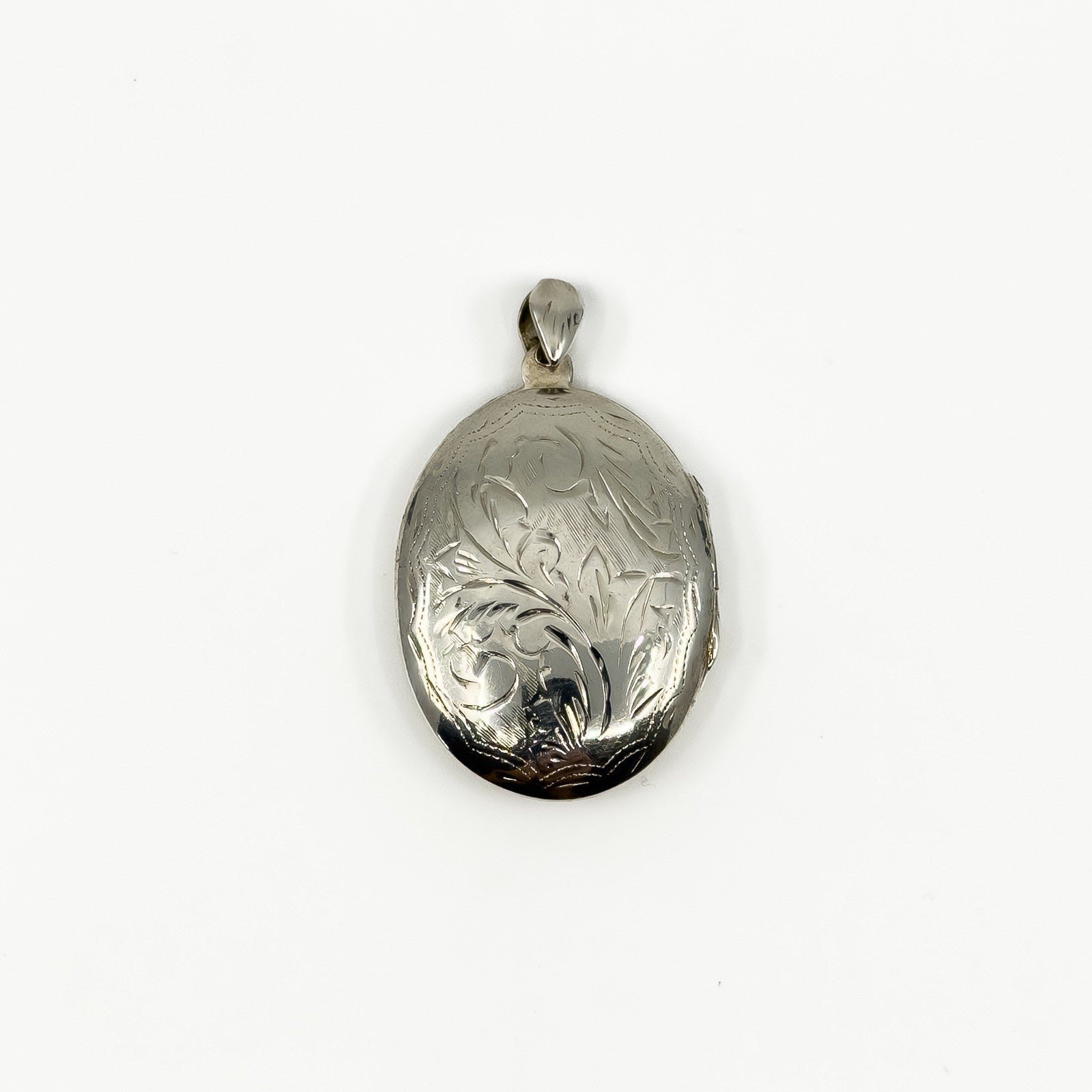 Vintage sterling silver oval engraved photo locket with polished bail and foliate detail
